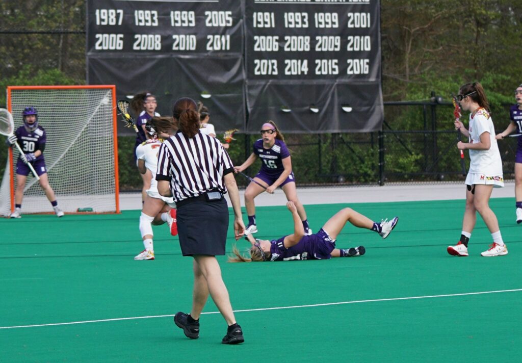 group of woman playing lacrosse